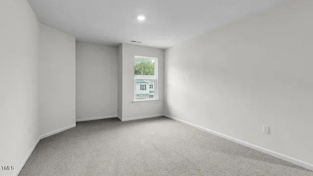 a view of an empty room and closet area