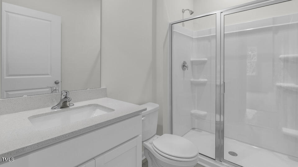 812 Comice Pear Way Willow Spring, NC 27592 - Photo 32 of 42 a bathroom with a sink toilet and shower