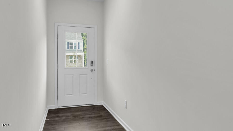 812 Comice Pear Way Willow Spring, NC 27592 - Photo 5 of 42 a view of an empty room with wooden floor and a window