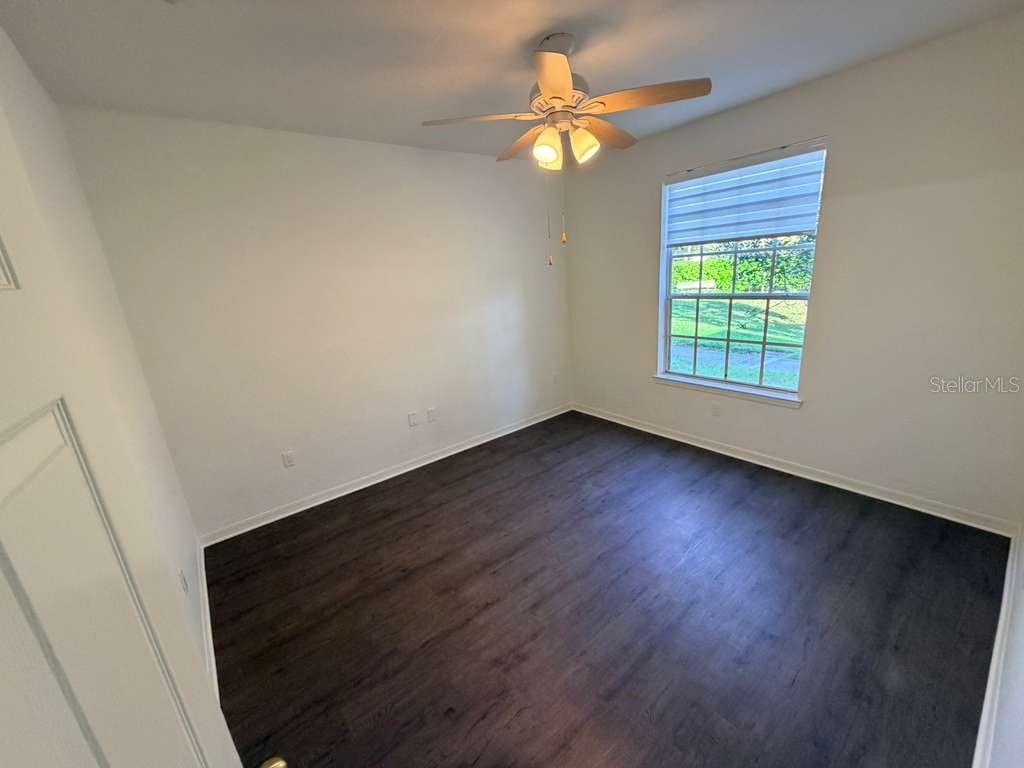 825 Grand Regency Point, Unit 102 Altamonte Springs, FL 32714 - Photo 11 of 29 wooden floor in an empty room with a window