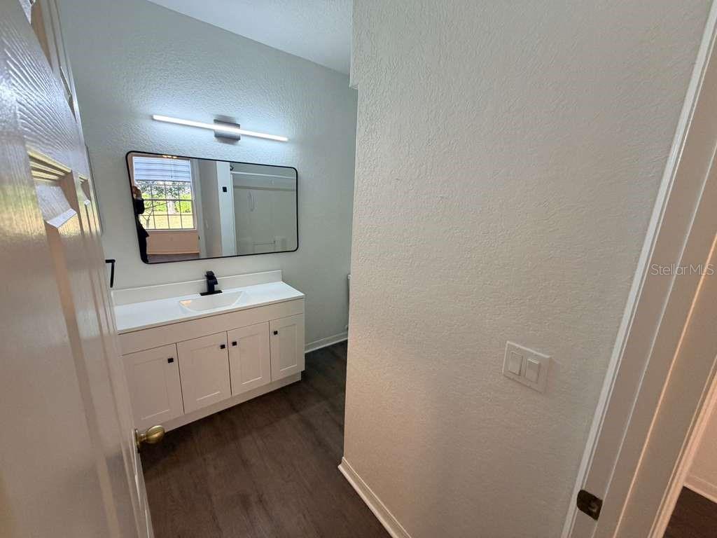 825 Grand Regency Point, Unit 102 Altamonte Springs, FL 32714 - Photo 13 of 29 a bathroom with double vanity sink and mirror
