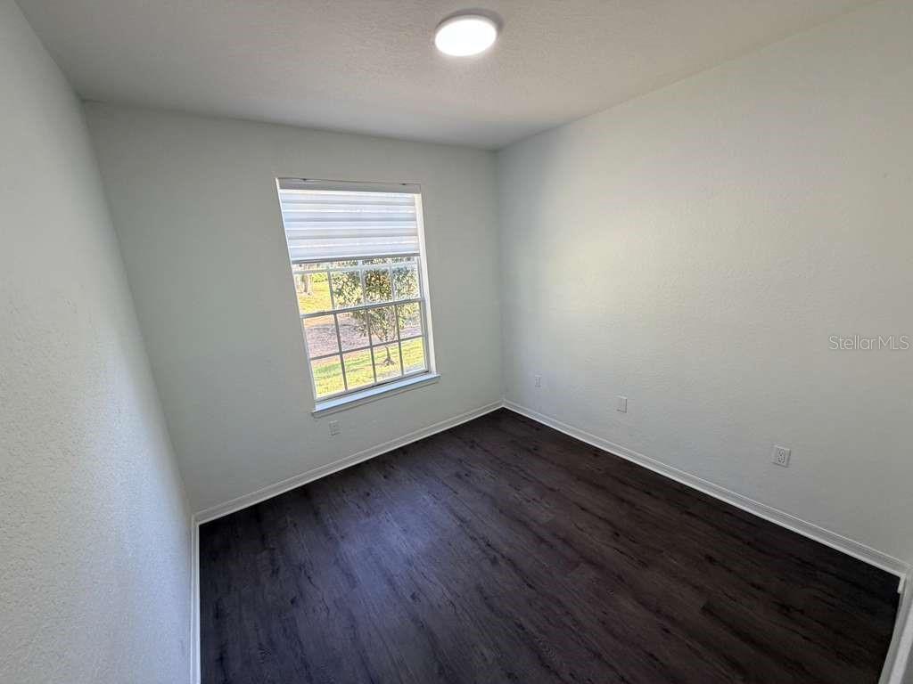 825 Grand Regency Point, Unit 102 Altamonte Springs, FL 32714 - Photo 18 of 29 a view of an empty room with wooden floor and a window