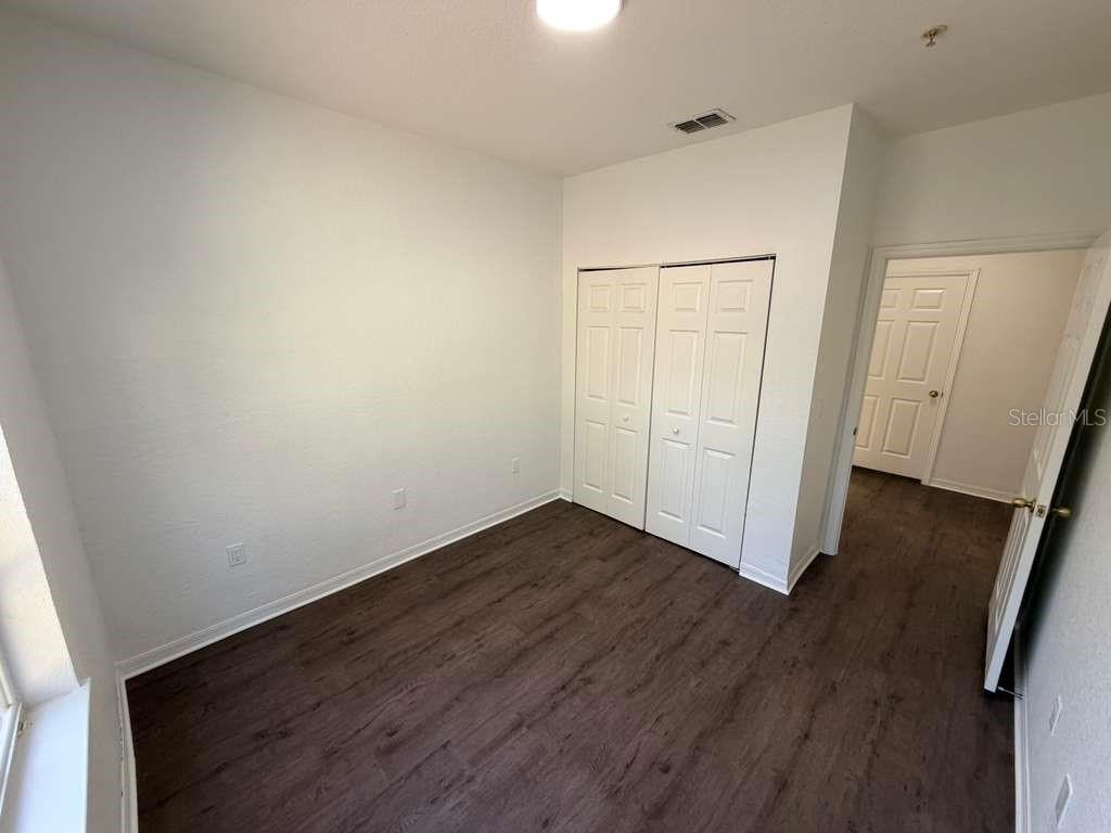 825 Grand Regency Point, Unit 102 Altamonte Springs, FL 32714 - Photo 19 of 29 an empty room with wooden floor