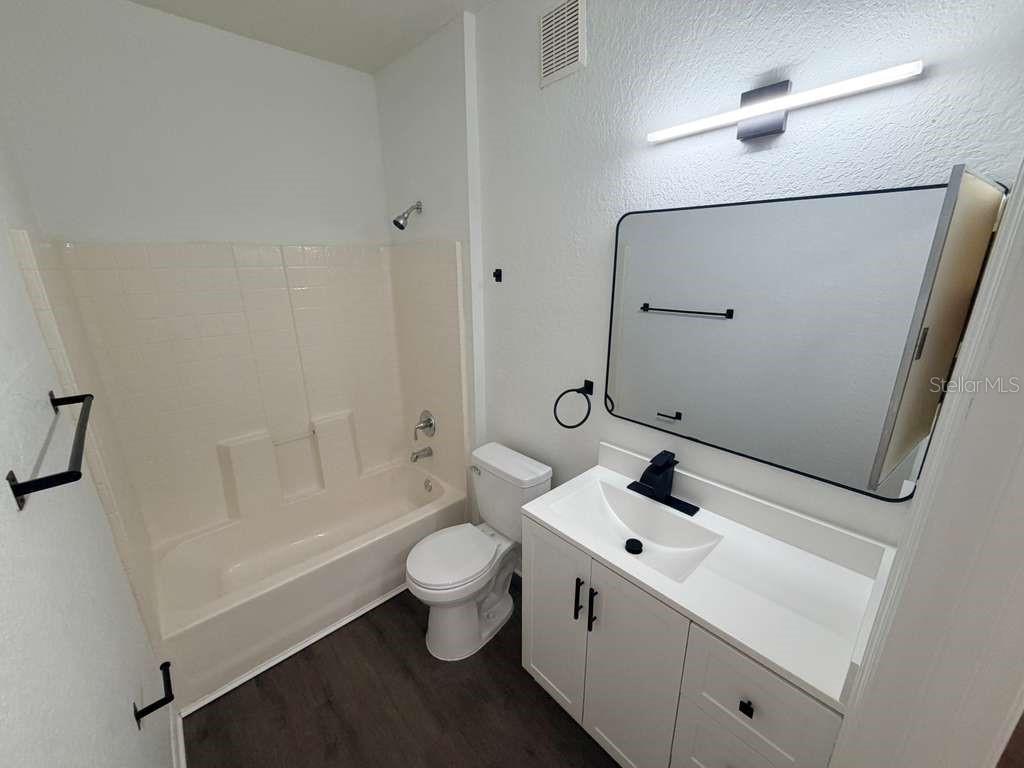 825 Grand Regency Point, Unit 102 Altamonte Springs, FL 32714 - Photo 20 of 29 a bathroom with a sink mirror toilet and shower