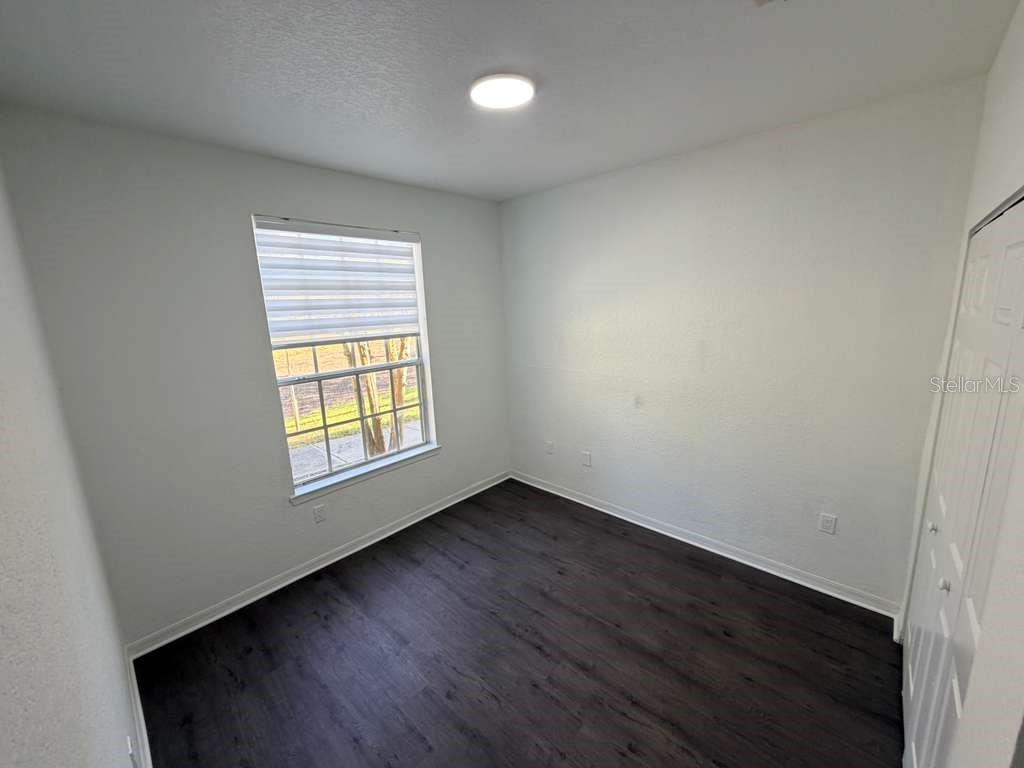 825 Grand Regency Point, Unit 102 Altamonte Springs, FL 32714 - Photo 21 of 29 an empty room with wooden floor and windows