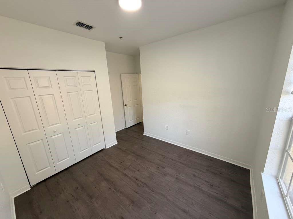 825 Grand Regency Point, Unit 102 Altamonte Springs, FL 32714 - Photo 22 of 29 a view of a hallway with wooden floor