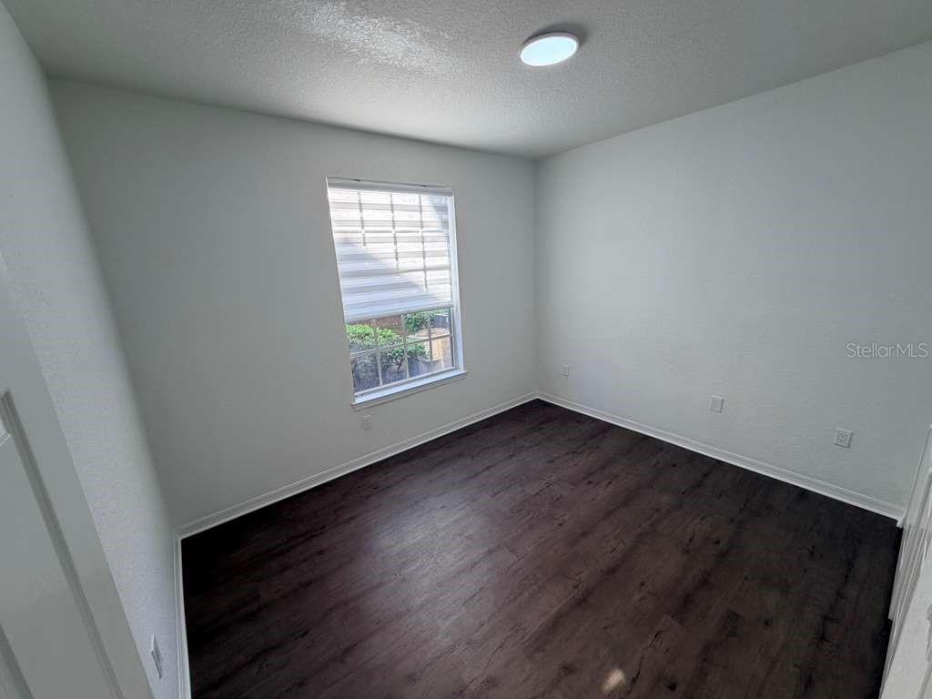 825 Grand Regency Point, Unit 102 Altamonte Springs, FL 32714 - Photo 23 of 29 an empty room with wooden floor and windows