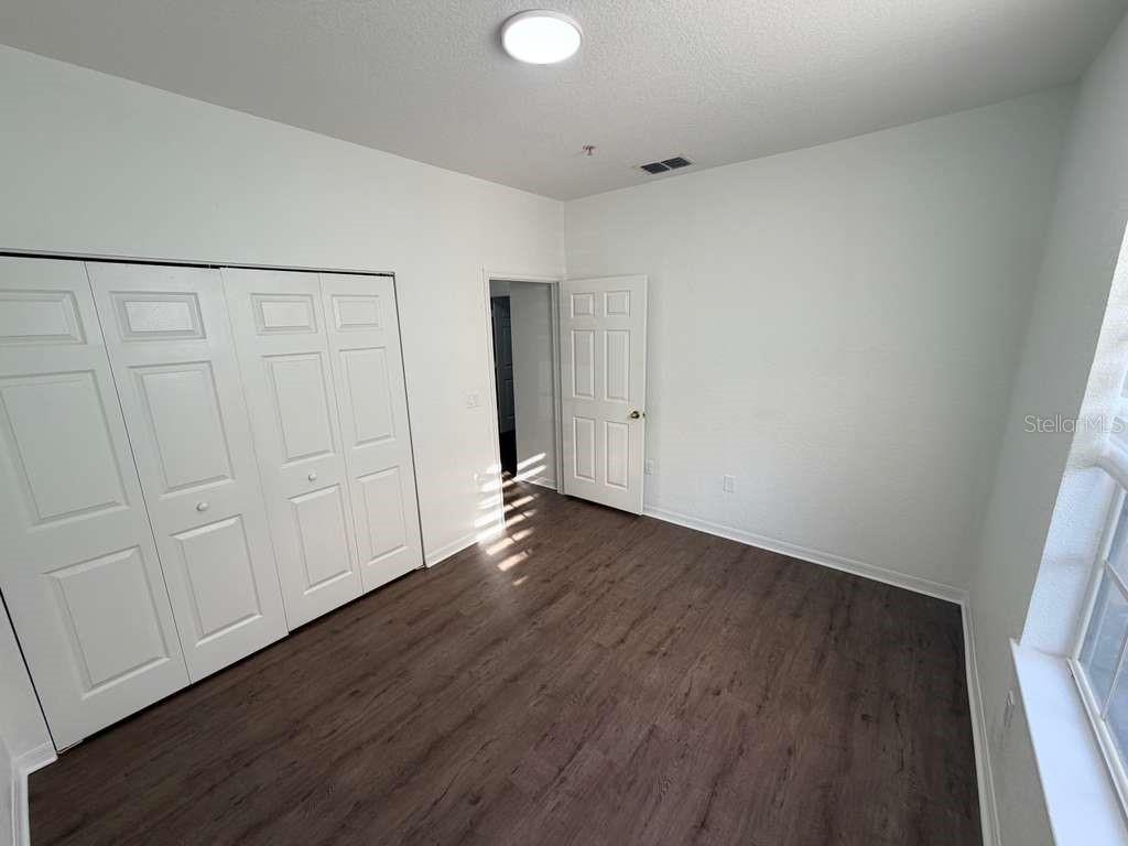 825 Grand Regency Point, Unit 102 Altamonte Springs, FL 32714 - Photo 24 of 29 a view of an empty room with wooden floor