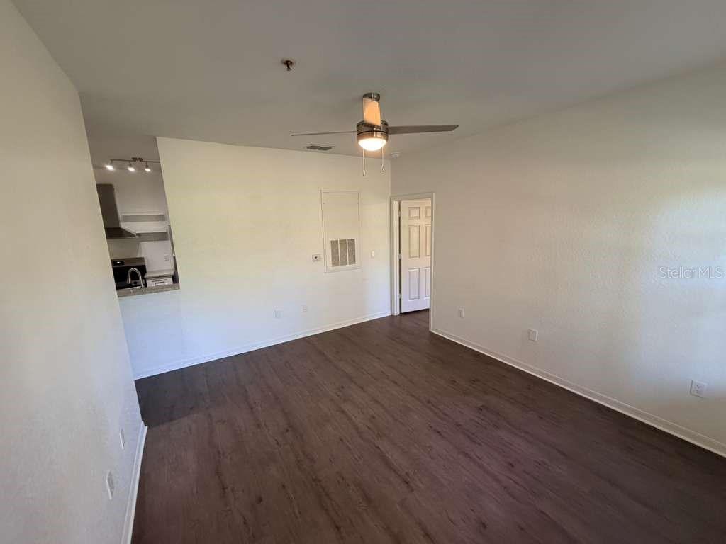 825 Grand Regency Point, Unit 102 Altamonte Springs, FL 32714 - Photo 3 of 29 an empty room with wooden floor and ceiling fan