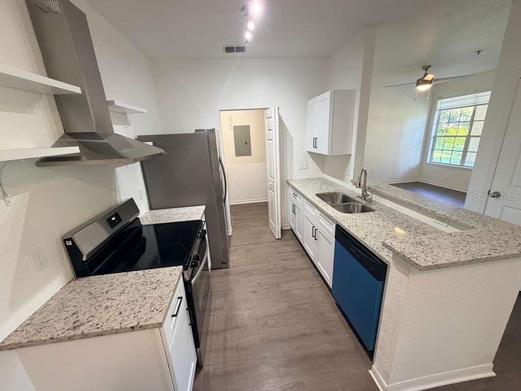 825 Grand Regency Point, Unit 102 Altamonte Springs, FL 32714 - Photo 6 of 29 a kitchen with granite countertop a sink and a stove