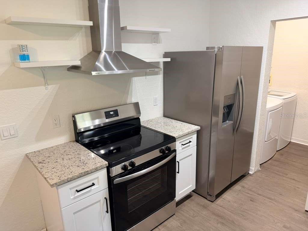 825 Grand Regency Point, Unit 102 Altamonte Springs, FL 32714 - Photo 7 of 29 a kitchen with a stove and a refrigerator