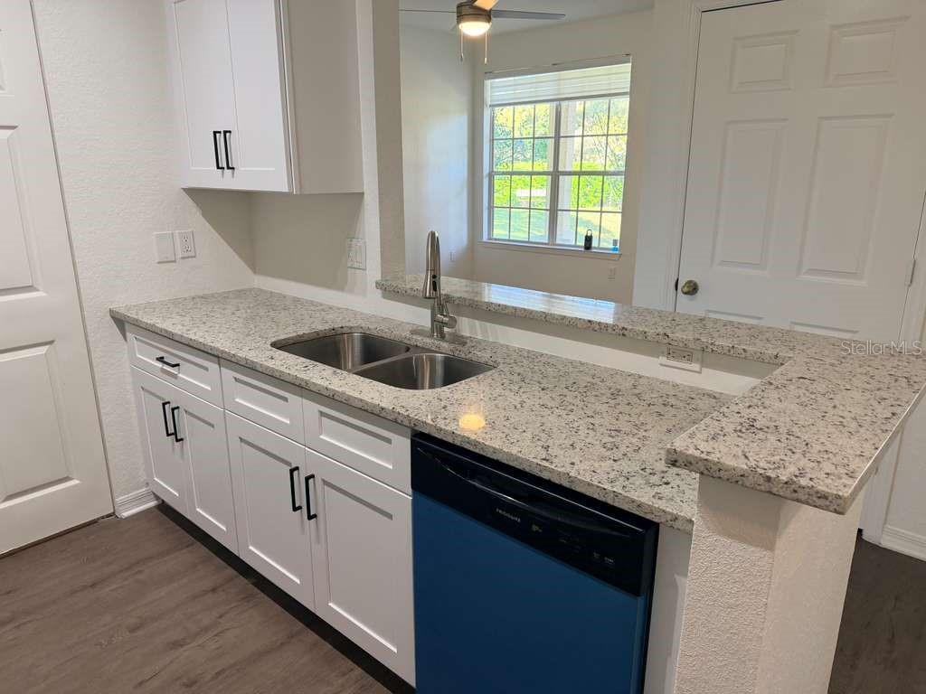 825 Grand Regency Point, Unit 102 Altamonte Springs, FL 32714 - Photo 8 of 29 a kitchen with granite countertop cabinets sink and window