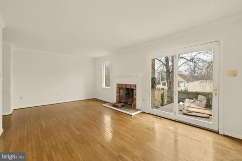 an empty room with floor to ceiling window and an empty room with wooden floor