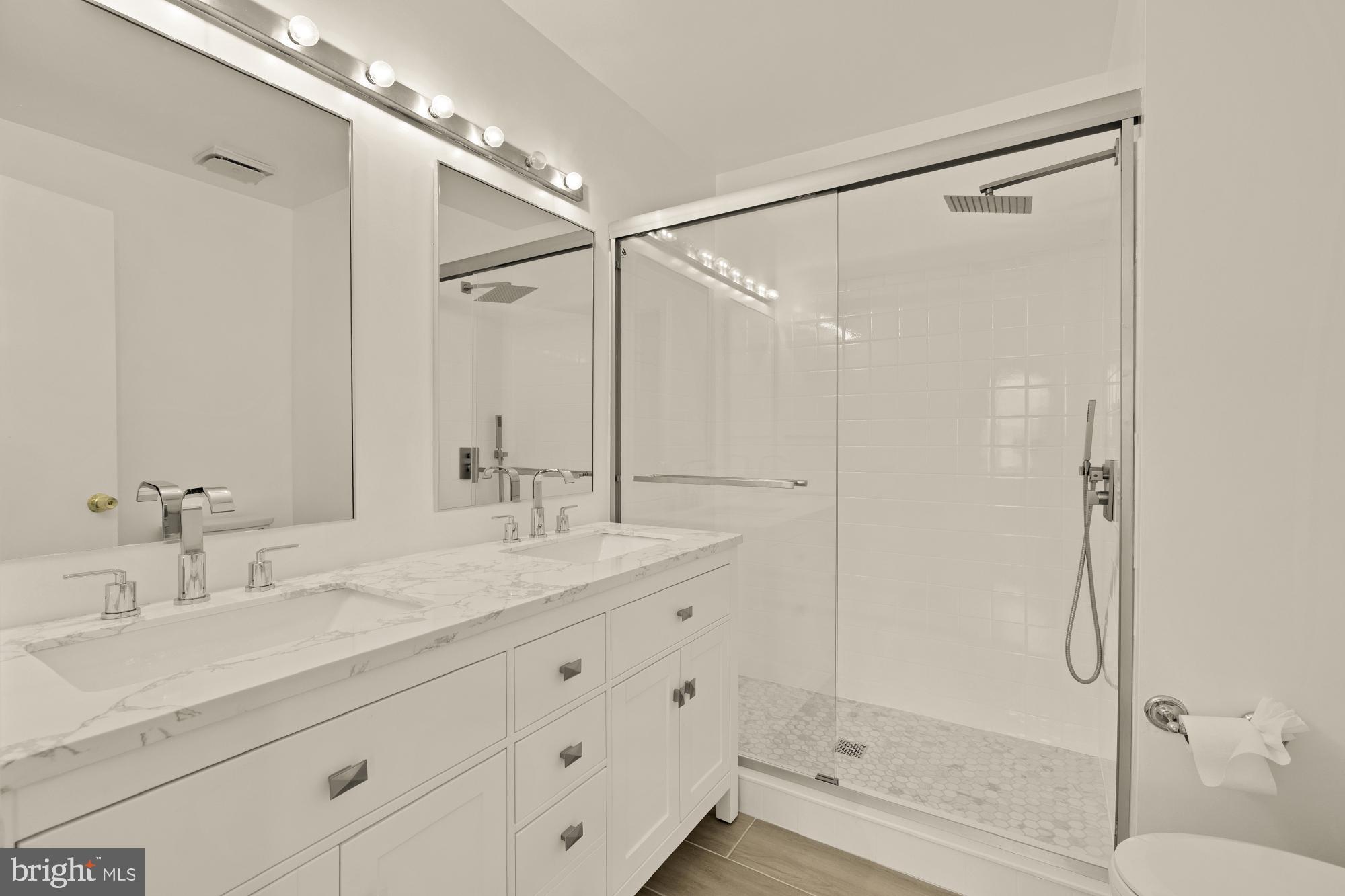 2 Spindrift Way Annapolis, MD 21403 - Photo 22 of 39 a bathroom with a granite countertop sink mirror and a shower