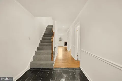 a view of entryway and hall with wooden floor