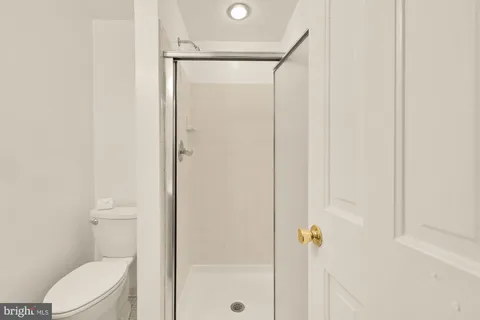 a bathroom with a shower a toilet and a sink
