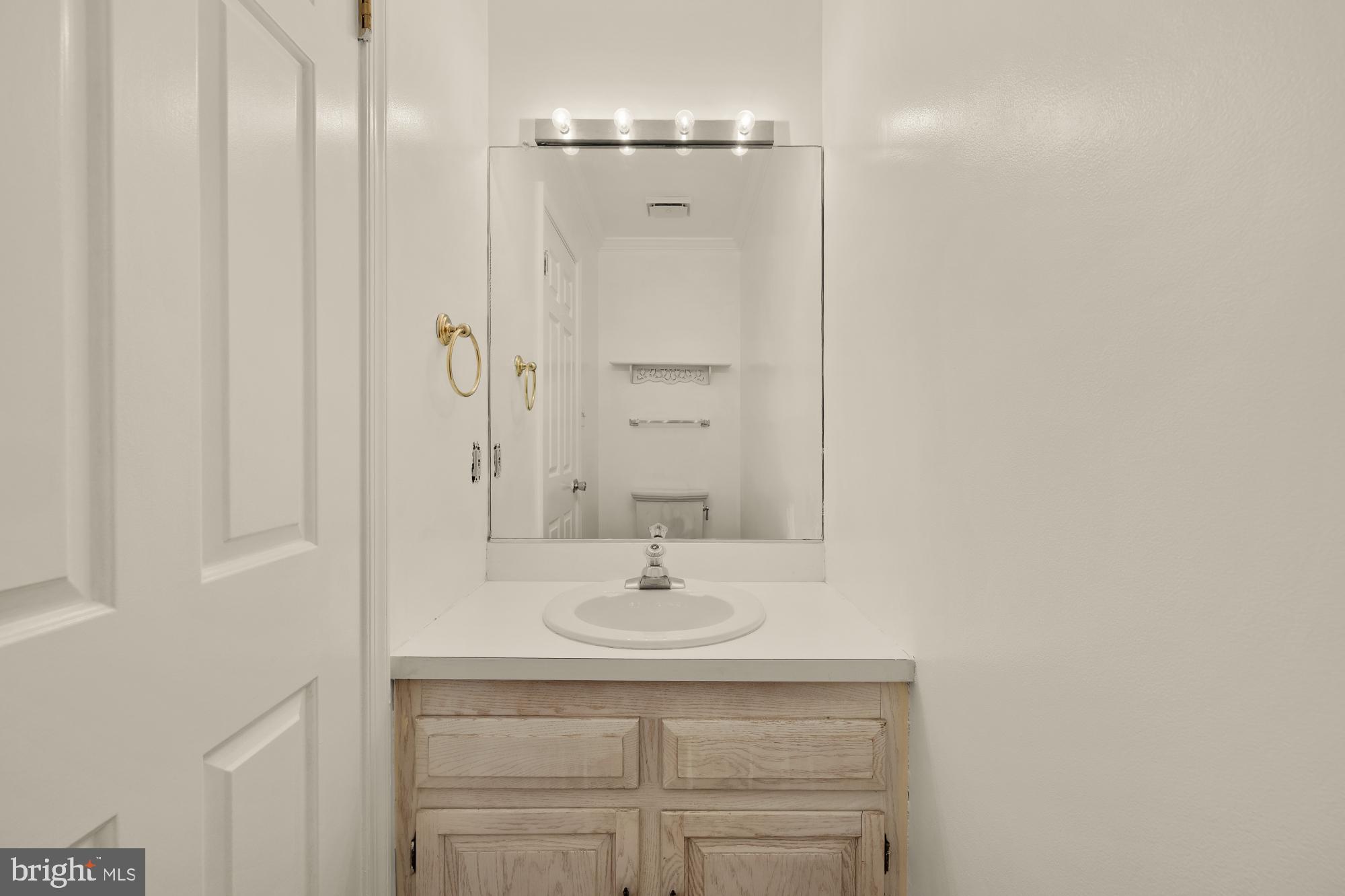 2 Spindrift Way Annapolis, MD 21403 - Photo 5 of 39 a bathroom with a sink a light fixture and a mirror