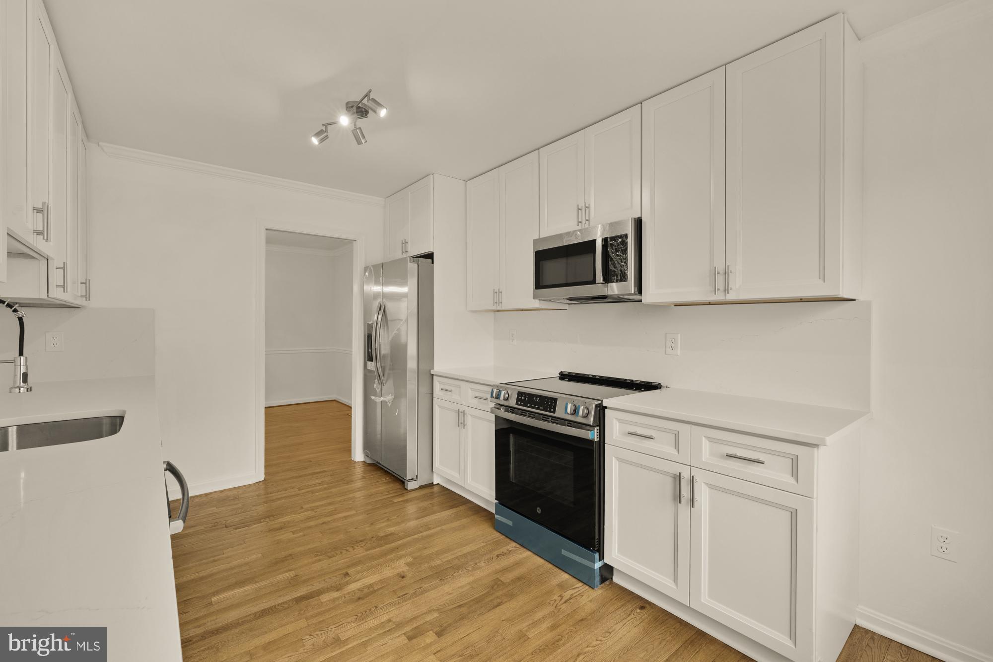 2 Spindrift Way Annapolis, MD 21403 - Photo 6 of 39 a kitchen with white cabinets and stainless steel appliances