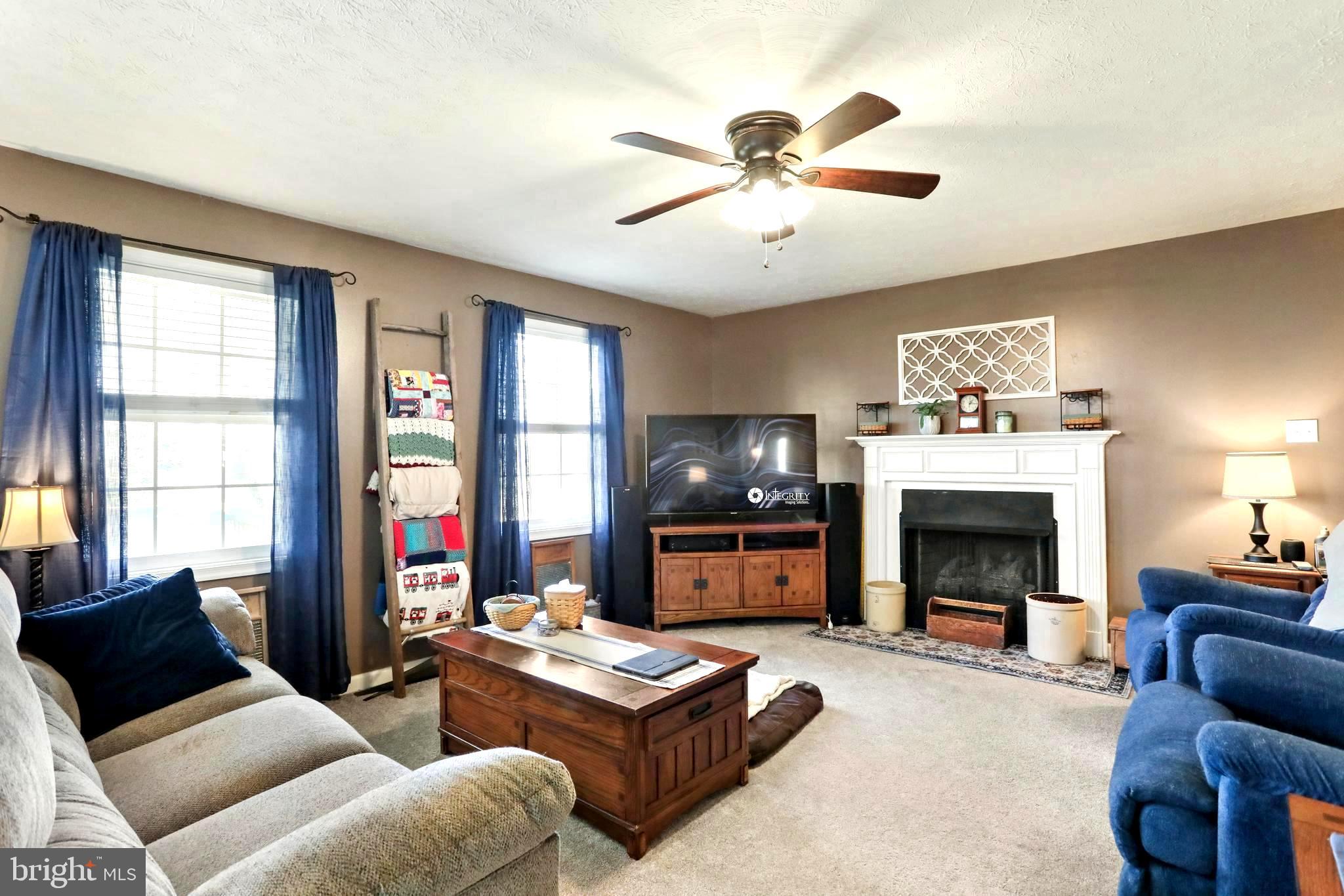 1147 Happy Ridge Drive Front Royal, VA 22630 - Photo 12 of 42 a living room with furniture a fireplace and a flat screen tv
