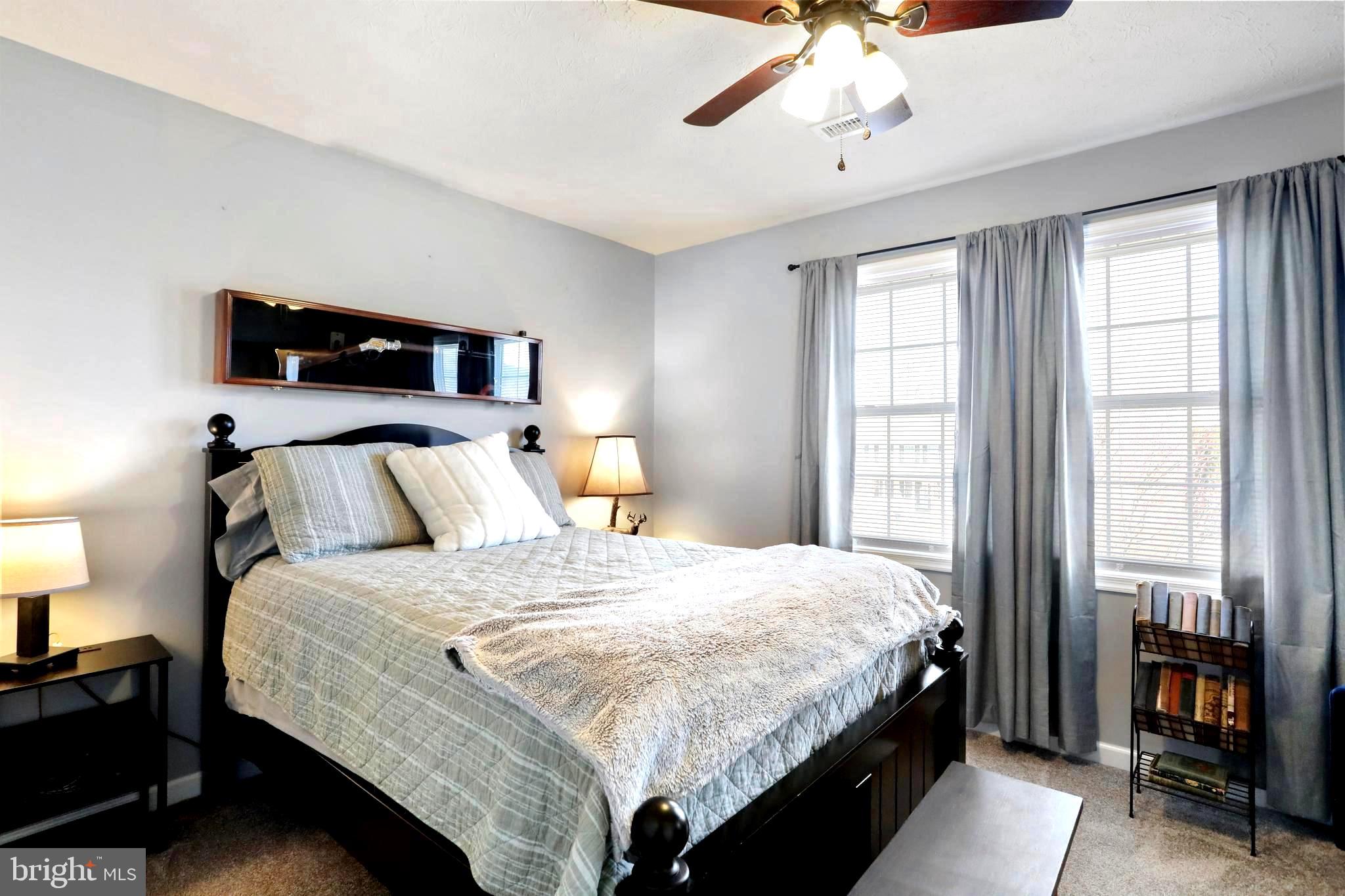 1147 Happy Ridge Drive Front Royal, VA 22630 - Photo 18 of 42 a bedroom with a bed and a chandelier