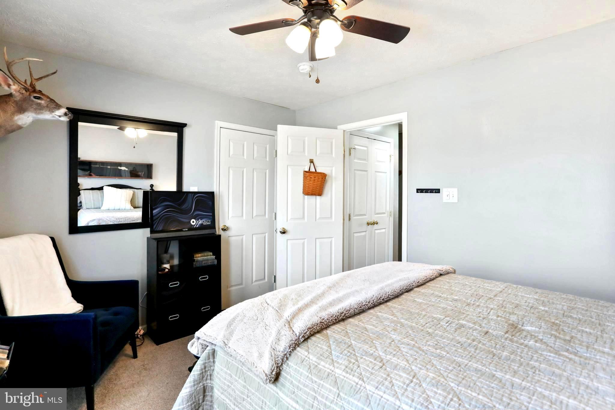 1147 Happy Ridge Drive Front Royal, VA 22630 - Photo 19 of 42 a bedroom with a bed and a chandelier