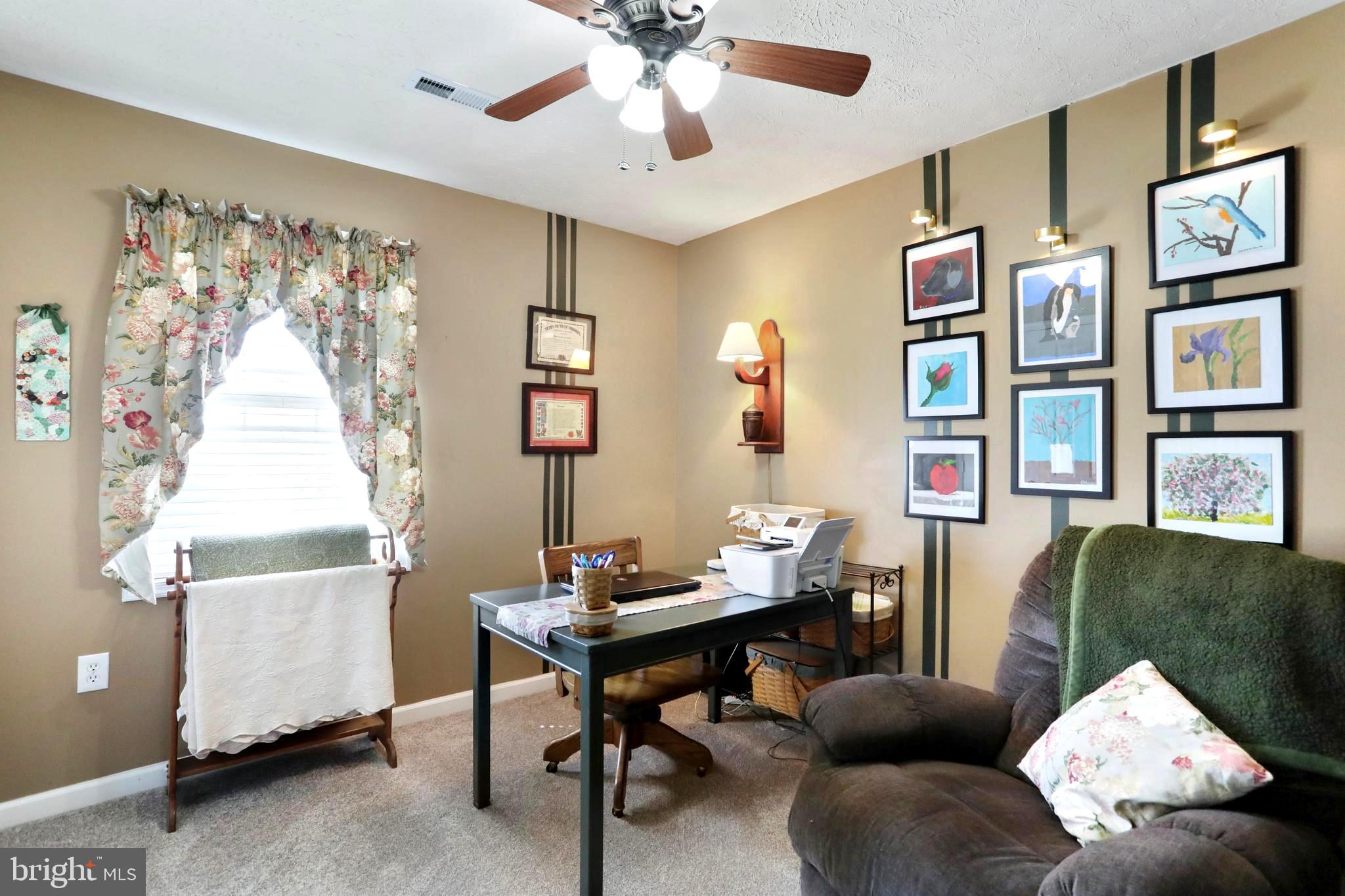 1147 Happy Ridge Drive Front Royal, VA 22630 - Photo 20 of 42 a living room with furniture and paintings on the wall
