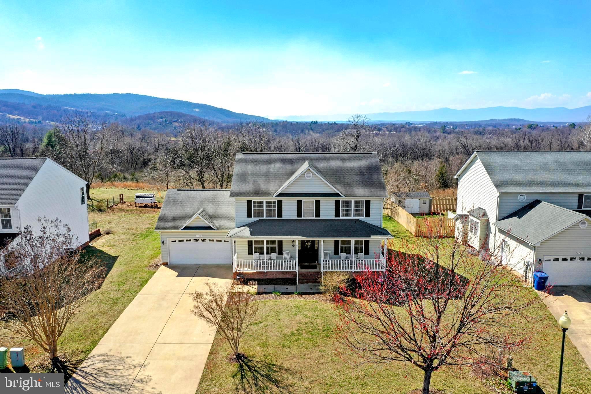 1147 Happy Ridge Drive Front Royal, VA 22630 - Photo 2 of 42 a view of a big house with a big yard and large trees