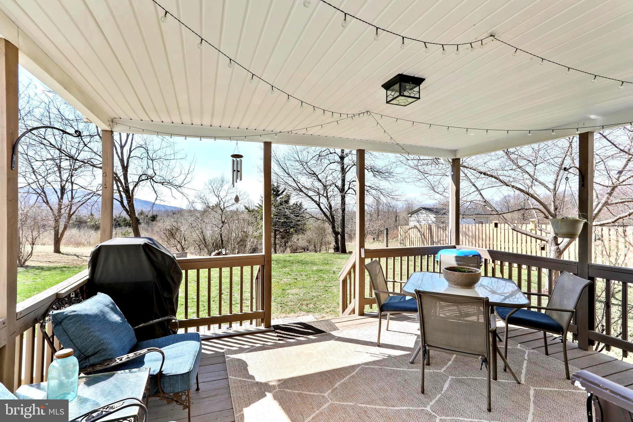 1147 Happy Ridge Drive Front Royal, VA 22630 - Photo 31 of 42 a porch with a bench next to a yard