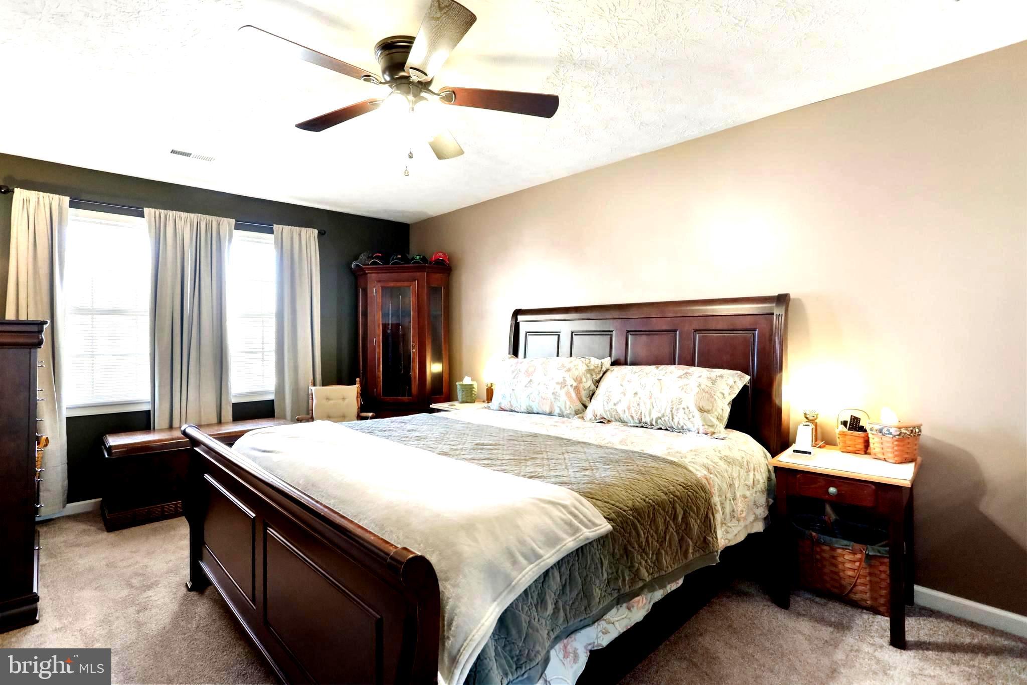 1147 Happy Ridge Drive Front Royal, VA 22630 - Photo 5 of 42 a bedroom with a bed and a chandelier