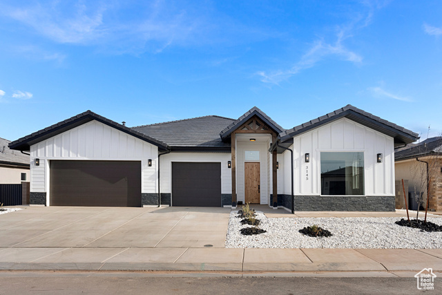 3145 Snow Cyn Road Hurricane, UT 84737 - Photo 2 of 38 Modern inspired farmhouse with board and batten siding, a garage, stone siding, a tiled roof, and driveway