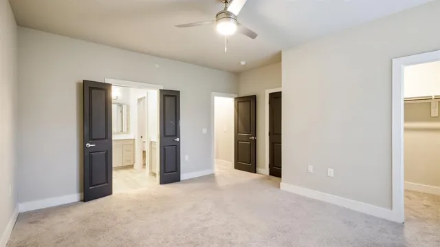 an empty room with closet and a bathroom