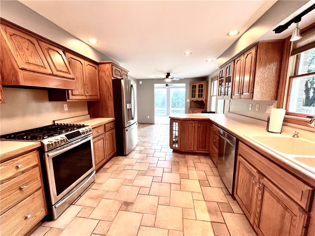 475 Bradys Ridge Road Beaver, PA 15009 - Photo 11 of 38 a kitchen with stainless steel appliances granite countertop a stove a sink and a microwave