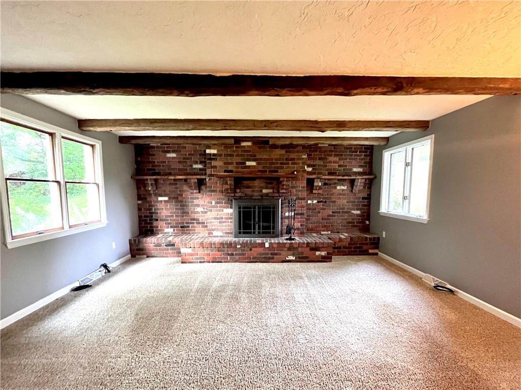 475 Bradys Ridge Road Beaver, PA 15009 - Photo 13 of 38 a view of an empty room with a fireplace and a window