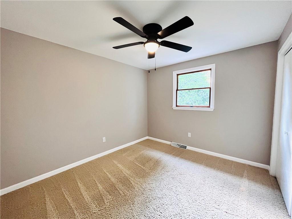 475 Bradys Ridge Road Beaver, PA 15009 - Photo 22 of 38 an empty room with ceiling fan and window