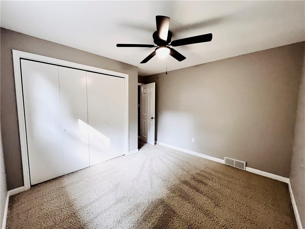 475 Bradys Ridge Road Beaver, PA 15009 - Photo 23 of 38 a view of empty room with wooden floor and fan