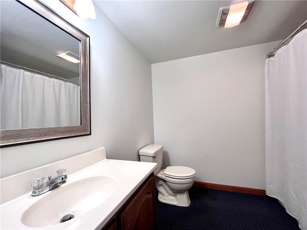 475 Bradys Ridge Road Beaver, PA 15009 - Photo 29 of 38 a white toilet sitting next to a bathroom sink