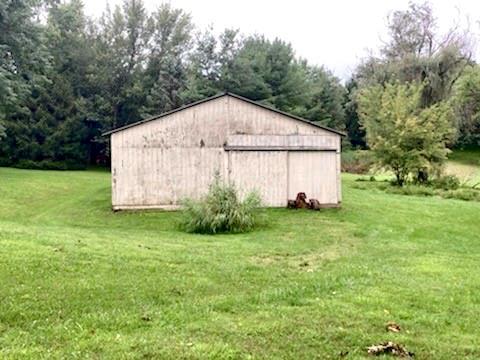 475 Bradys Ridge Road Beaver, PA 15009 - Photo 34 of 38 a view of a backyard with potted plants and large tree