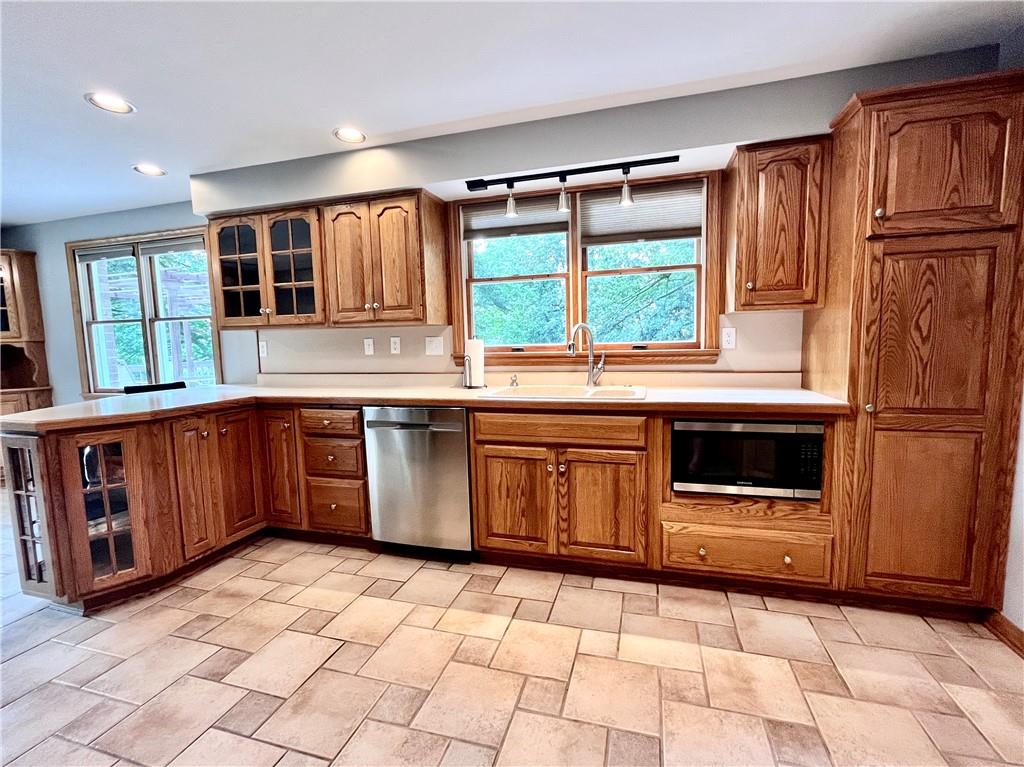 475 Bradys Ridge Road Beaver, PA 15009 - Photo 10 of 38 a kitchen with stainless steel appliances granite countertop a stove a sink and a refrigerator