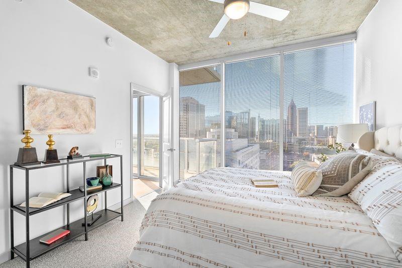 60 11th Street Northeast, Unit 2D Atlanta, GA 30309 - Photo 2 of 7 a bedroom with a bed and a chandelier