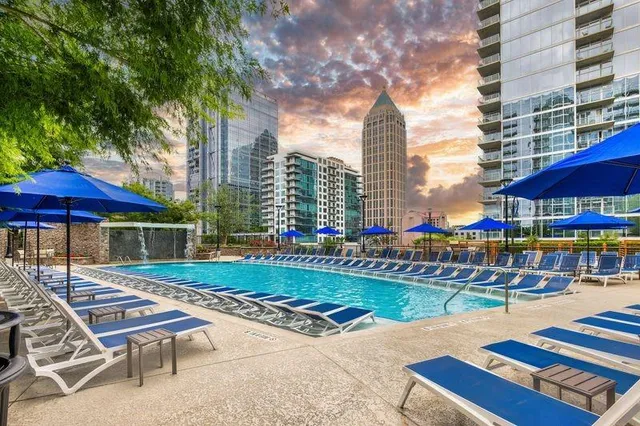 a view of a patio with a table and chairs under an umbrella