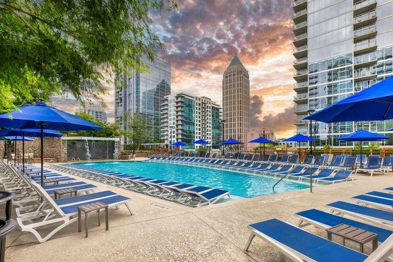 60 11th Street Northeast, Unit 2D Atlanta, GA 30309 - Photo 4 of 7 a view of a patio with a table and chairs under an umbrella