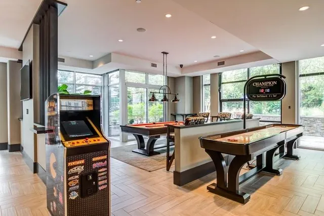 a living room with furniture a flat screen tv and a table