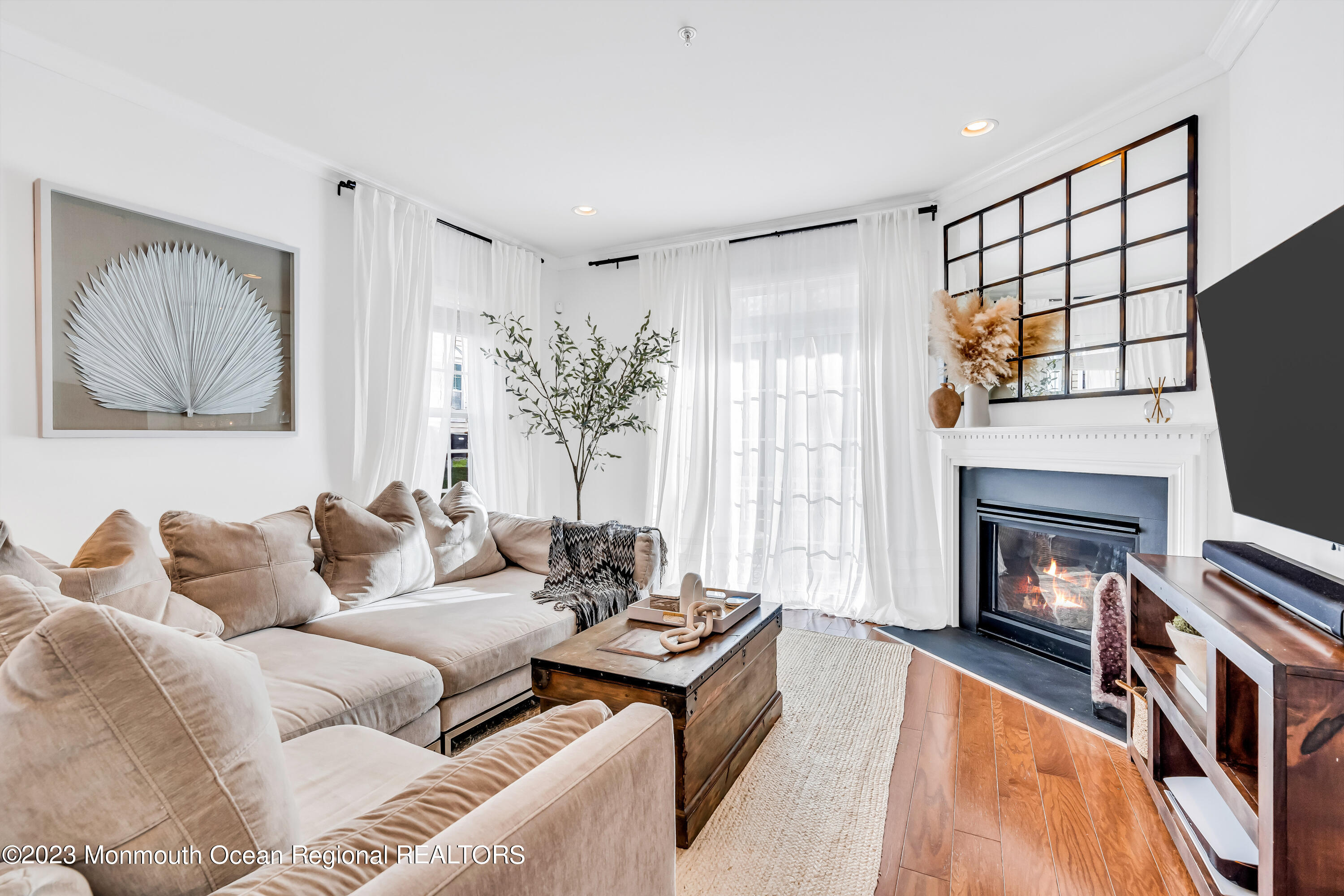 310 April Way Middletown, NJ 07748 - Photo 12 of 31 a living room with furniture a flat screen tv and a fireplace