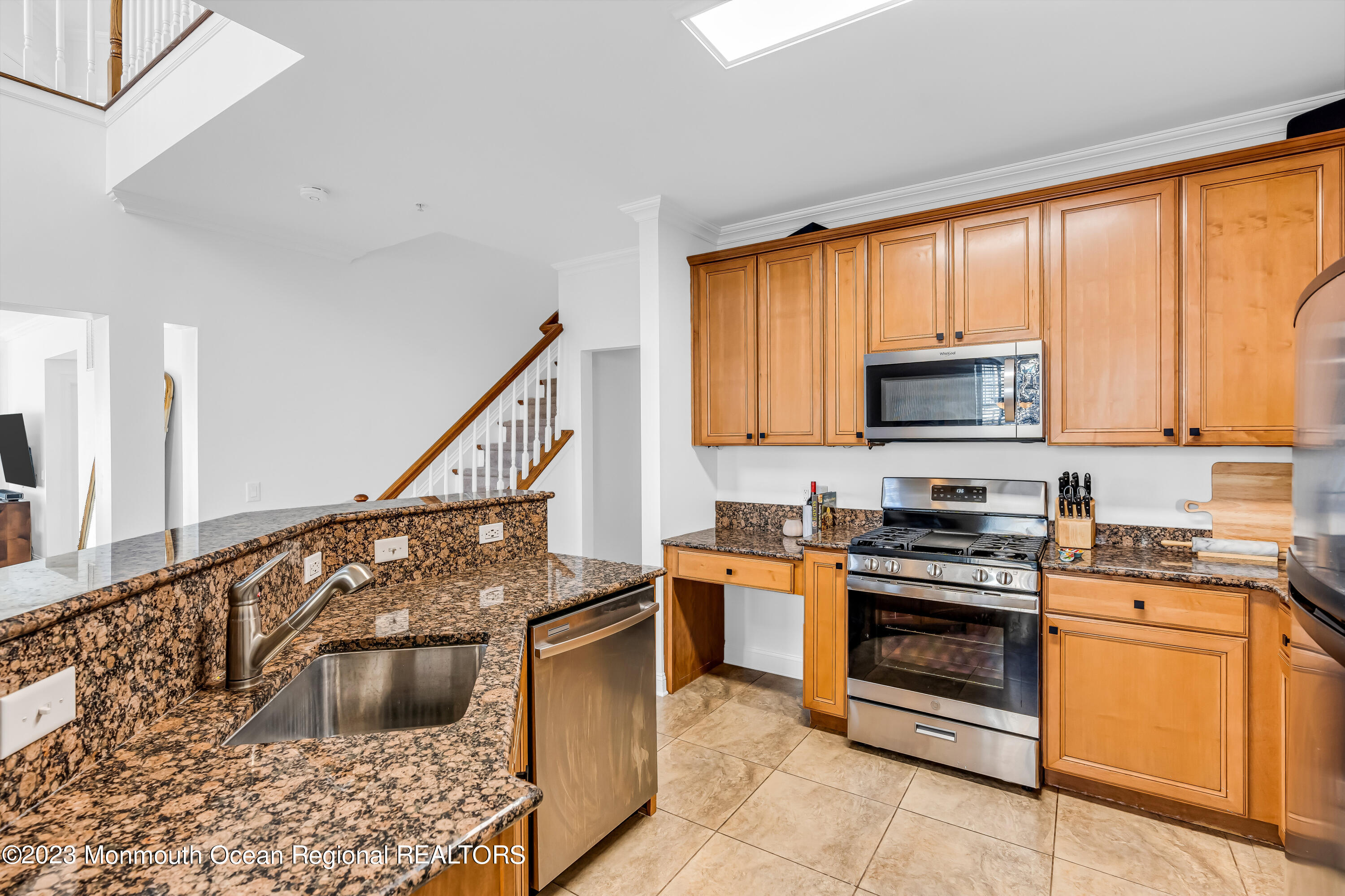 310 April Way Middletown, NJ 07748 - Photo 8 of 31 a kitchen with granite countertop a stove a sink and a microwave