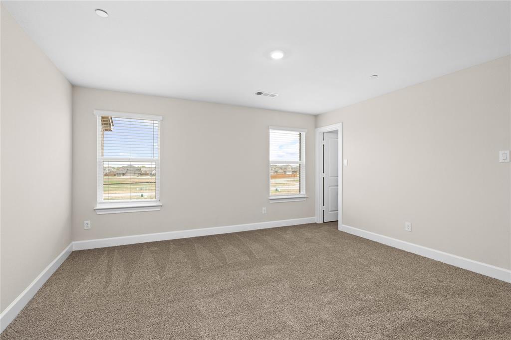 726 Carson Lane Pilot Point, TX 76258 - Photo 4 of 8 an empty room with windows