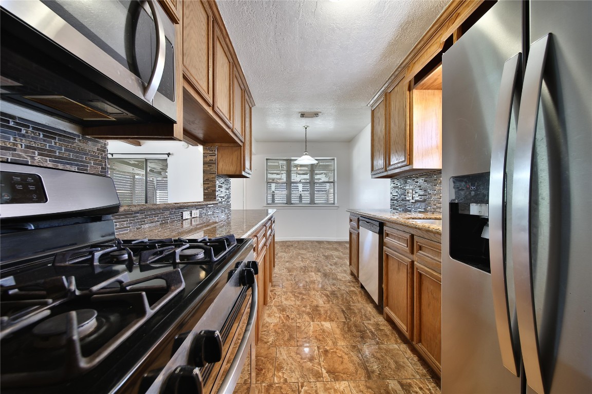 990 Redway Lane Houston, TX 77062 - Photo 11 of 21 a kitchen with stainless steel appliances granite countertop a stove and a refrigerator
