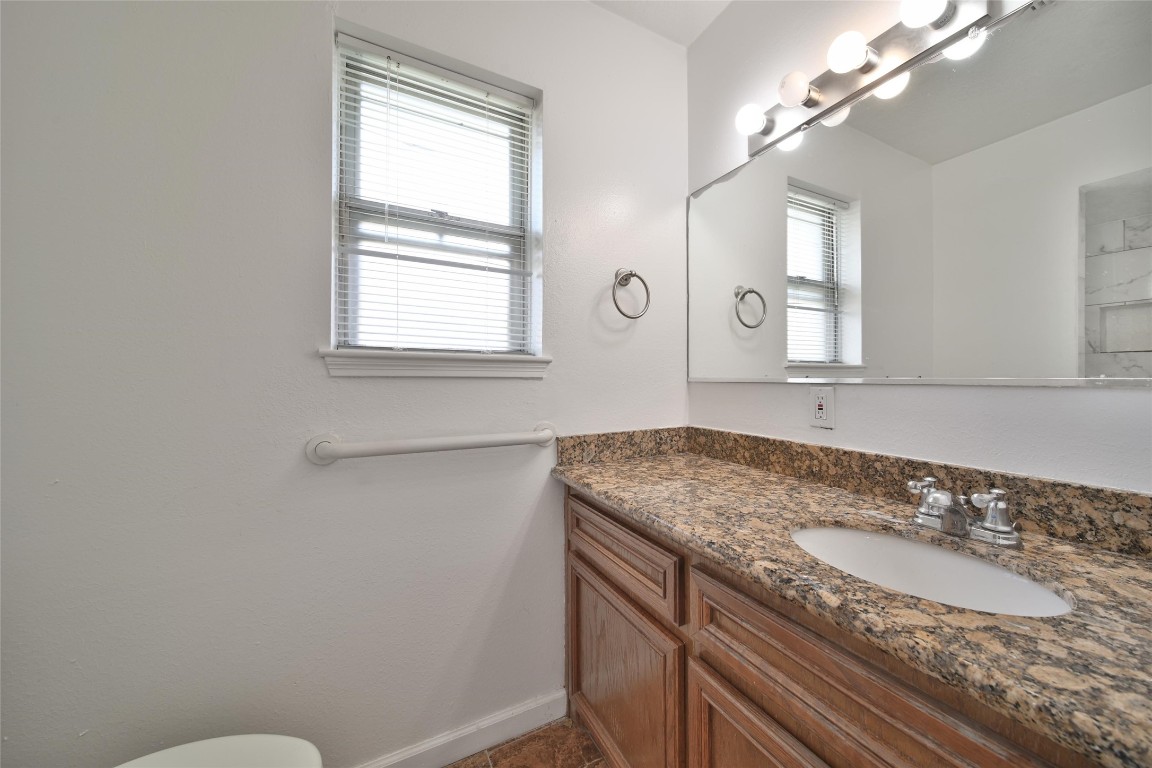 990 Redway Lane Houston, TX 77062 - Photo 15 of 21 a bathroom with a granite countertop sink a mirror and a window