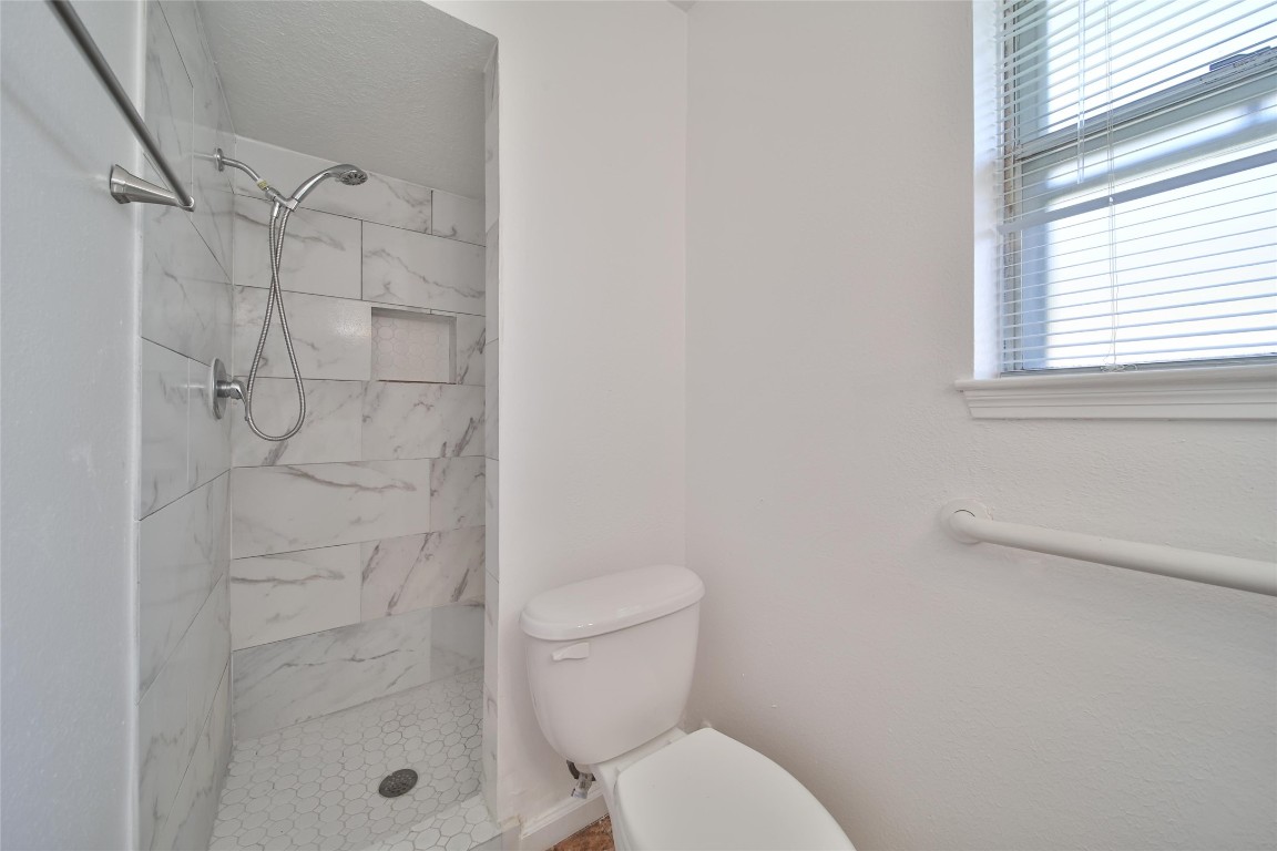 990 Redway Lane Houston, TX 77062 - Photo 16 of 21 a bathroom with a toilet and shower