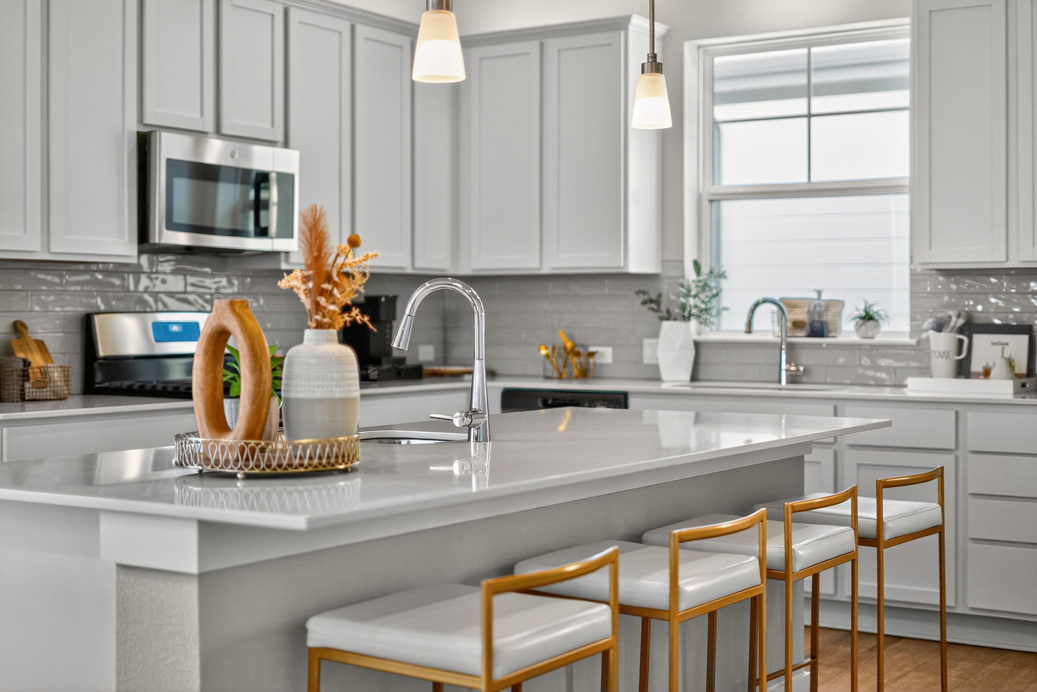 5902 Rotunda View Austin, TX 78747 - Photo 7 of 38 Kitchen with stainless steel appliances, pendant lighting, decorative backsplash, a kitchen breakfast bar, and a center island with sink