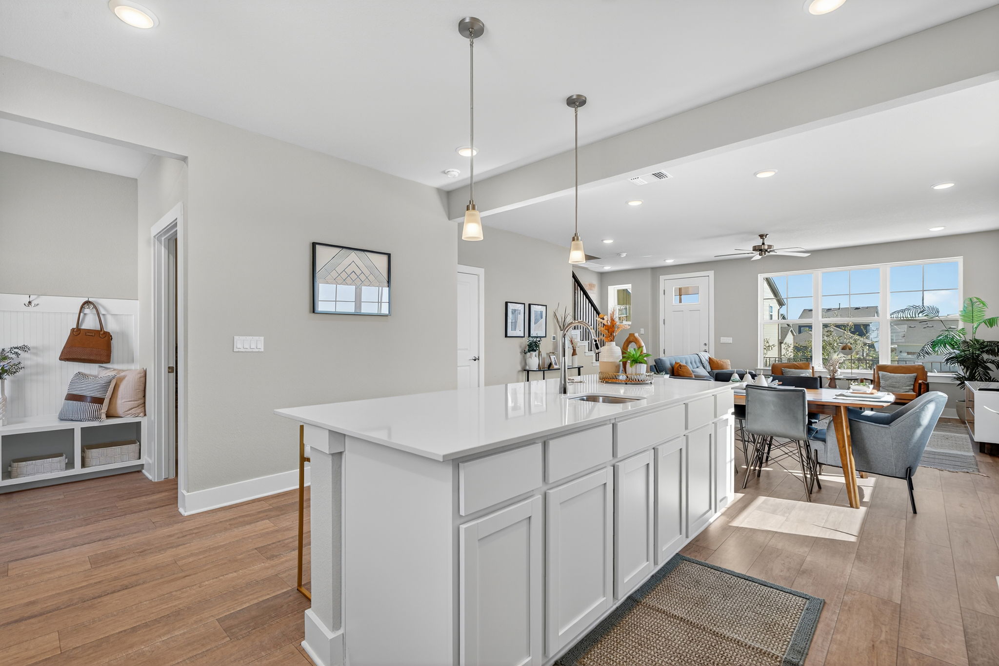 5902 Rotunda View Austin, TX 78747 - Photo 10 of 38 Kitchen with white cabinetry, pendant lighting, light wood-style floors, and an island with sink